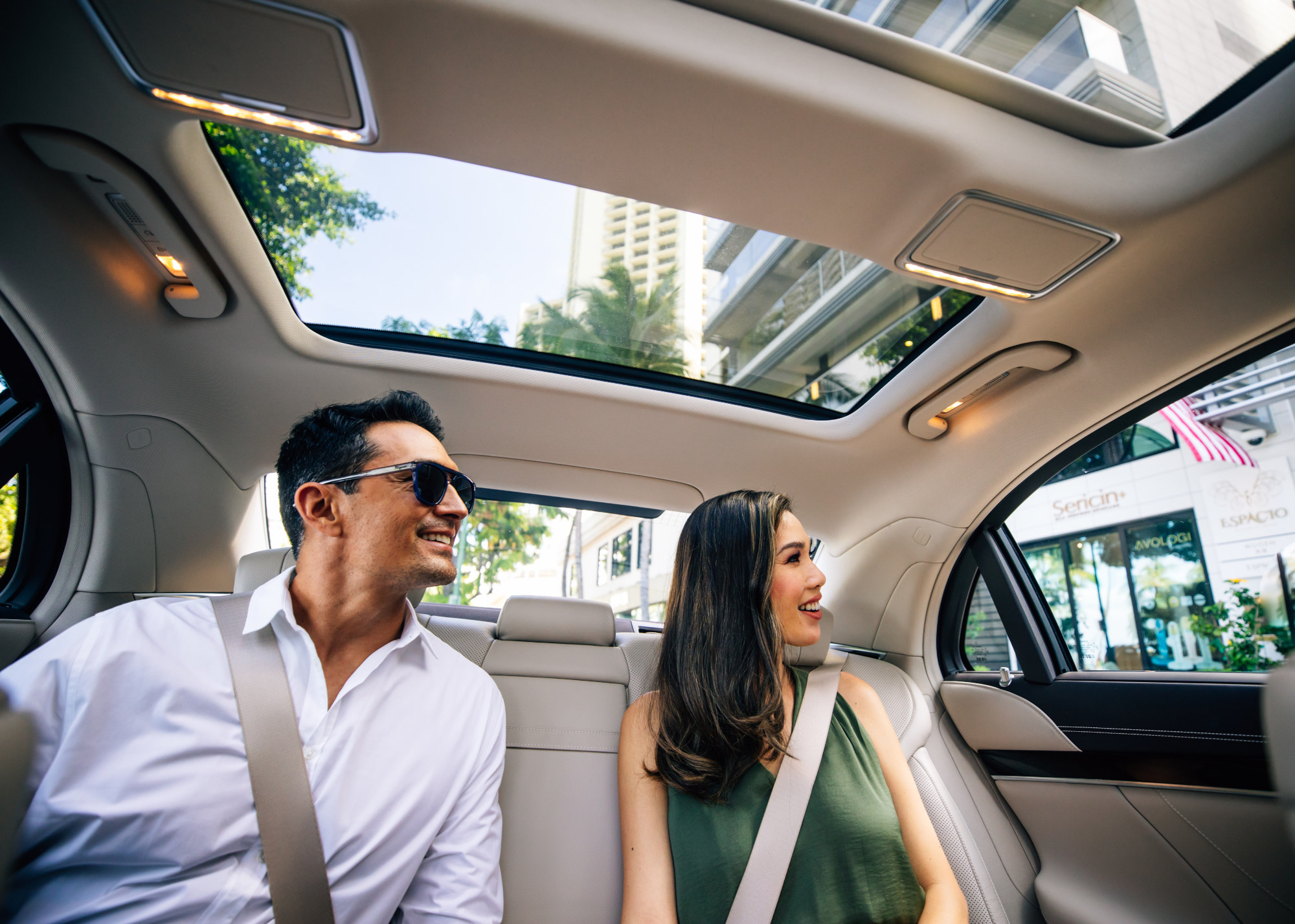 Man and Woman riding in the car driven by Espacio Driver